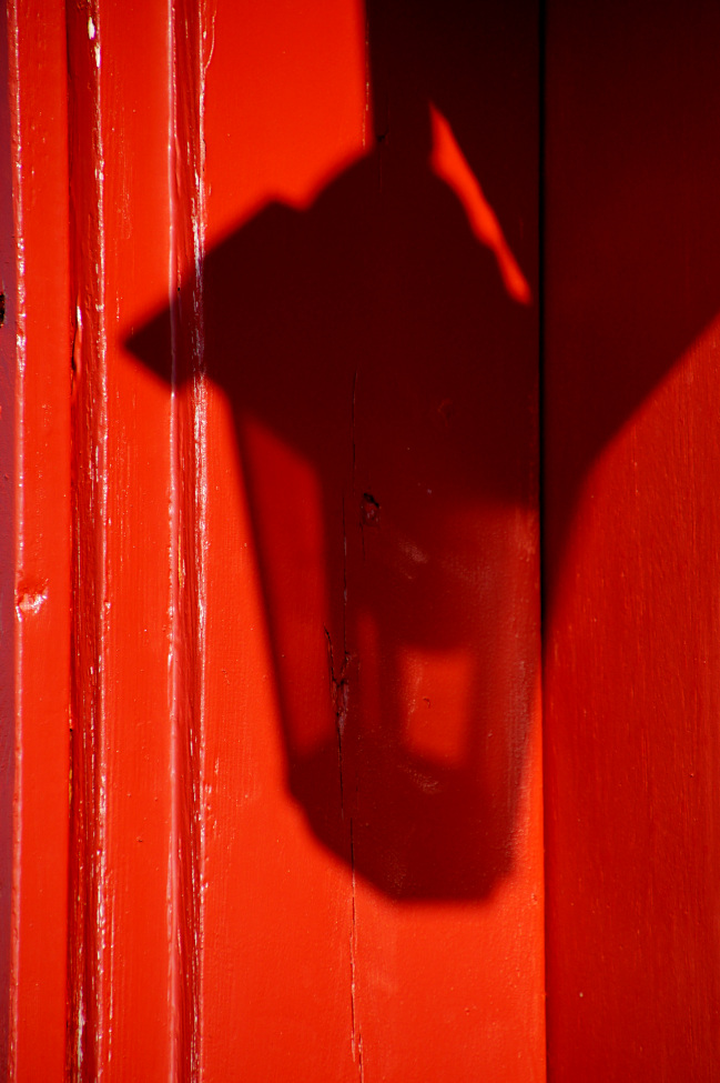 Shadow on the red door in Hellnar
