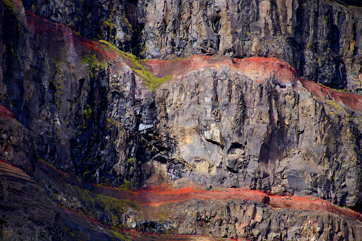 basaltic strata with thin, red layers of clay between the basaltic layers